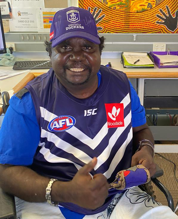 Ethan in the studio, wearing his Fremantle Dockers guernsey. 