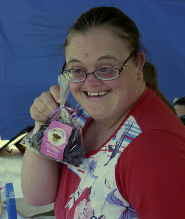 Claire Photo2 Claire smiling with a packet of her pet treats in hand