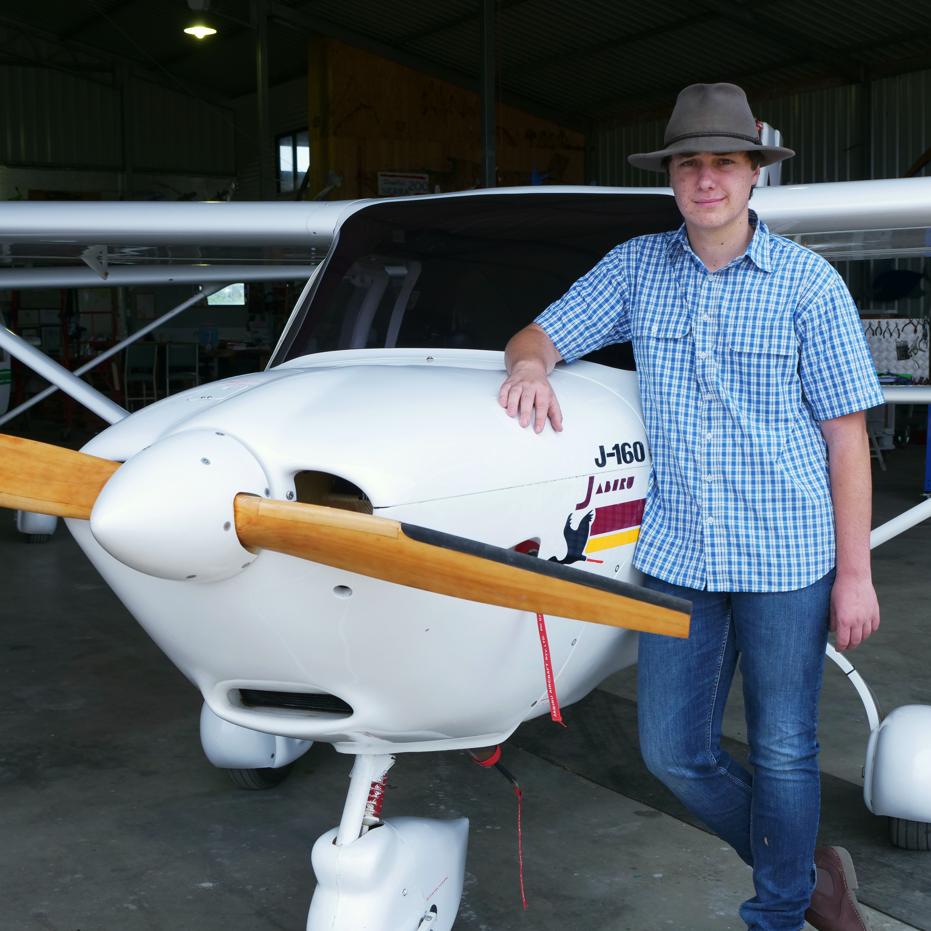 Hayden standing next to a small plane