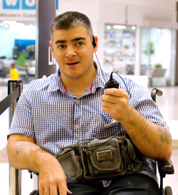 Luke working at Kmart talking to a walkie talkie.