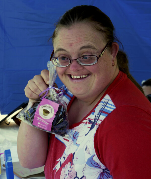 Claire smiling with a packet of her pet treats in hand